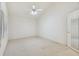 Light and airy bedroom with neutral carpet, a ceiling fan, and closet, offering comfort and tranquility at 13636 Lake Point S Dr, Clearwater, FL 33762