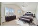Well-lit bedroom with bench, dresser, and large windows with plantation shutters at 13636 Lake Point S Dr, Clearwater, FL 33762