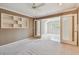Neutral bedroom featuring an adjacent sitting room and a custom built-in bookshelf at 13636 Lake Point S Dr, Clearwater, FL 33762