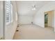 Bright bedroom with vaulted ceiling, ceiling fan, shuttered windows and lots of natural light at 13636 Lake Point S Dr, Clearwater, FL 33762