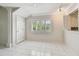 Dining area with tile flooring and shuttered windows, adjacent to the kitchen at 13636 Lake Point S Dr, Clearwater, FL 33762