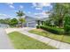 Beautiful single-story home with a two-car garage and well-manicured front lawn at 13636 Lake Point S Dr, Clearwater, FL 33762