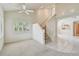 Bright foyer featuring a staircase, tile flooring, and views into other rooms with seamless transition at 13636 Lake Point S Dr, Clearwater, FL 33762