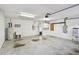 Spacious garage with utility sink, water heater, and electrical panel at 13636 Lake Point S Dr, Clearwater, FL 33762