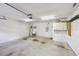 Clean garage interior with concrete floor, utility sink, and white cabinets at 13636 Lake Point S Dr, Clearwater, FL 33762