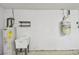 Garage sink with hot water heater and shelf for cleaning products at 13636 Lake Point S Dr, Clearwater, FL 33762