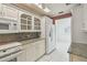 A well-lit kitchen featuring granite countertops, white cabinetry, and modern appliances at 13636 Lake Point S Dr, Clearwater, FL 33762