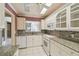 Well-lit kitchen features white cabinetry, granite countertops, and stainless appliances at 13636 Lake Point S Dr, Clearwater, FL 33762