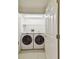 Cozy laundry room featuring a washer and dryer with white cabinets at 13636 Lake Point S Dr, Clearwater, FL 33762