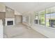 Bright living room with fireplace, shuttered windows, and a vaulted ceiling for a cozy, open feel at 13636 Lake Point S Dr, Clearwater, FL 33762