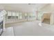 Bright living room with large windows, fireplace, and stairs with tile accents at 13636 Lake Point S Dr, Clearwater, FL 33762