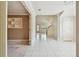 Open floor plan features tile flooring leading to a living room and staircase at 13636 Lake Point S Dr, Clearwater, FL 33762