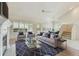 Bright living room featuring vaulted ceilings, a fireplace, and an open layout with lots of natural light at 13636 Lake Point S Dr, Clearwater, FL 33762