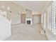 Spacious living room showcasing a vaulted ceiling, fan, fireplace, and white plantation shutters at 13636 Lake Point S Dr, Clearwater, FL 33762