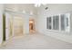 Bright, spacious main bedroom featuring neutral carpet, plantation shutters, ensuite access, and a closet at 13636 Lake Point S Dr, Clearwater, FL 33762