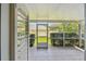Screened porch with tile floors providing a relaxing outdoor space with lush backyard views at 13636 Lake Point S Dr, Clearwater, FL 33762