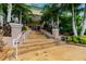 Grand entrance with stone steps and tropical landscaping at 13636 Lake Point S Dr, Clearwater, FL 33762
