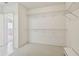 Spacious walk-in closet featuring carpeted floors and metal shelving at 13636 Lake Point S Dr, Clearwater, FL 33762