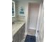 Updated bathroom with gray vanity, white marble floor, updated lighting, and a beach-themed decor at 1380 Gulf Blvd # 805, Clearwater, FL 33767