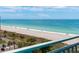 Scenic beach view from a balcony, showcasing clear waters, sandy shores, and a distant sailboat at 1380 Gulf Blvd # 805, Clearwater, FL 33767