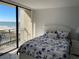 Light-filled bedroom with ocean view from the balcony, coastal decor, and white accents at 1380 Gulf Blvd # 805, Clearwater, FL 33767