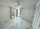 Airy bedroom with ocean view, ceiling fan, balcony, and marble tile floor at 1380 Gulf Blvd # 805, Clearwater, FL 33767