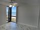 Bright bedroom with beach views, a ceiling fan, access to balcony, and stylish flooring at 1380 Gulf Blvd # 805, Clearwater, FL 33767