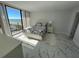 Bright bedroom featuring modern decor, a cozy bed, and a large window with an ocean view at 1380 Gulf Blvd # 805, Clearwater, FL 33767