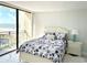 Bedroom with ocean view and decor with a beachside theme including a white bed and nightstand at 1380 Gulf Blvd # 805, Clearwater, FL 33767