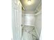 Spacious walk-in closet featuring white wire shelving and modern marble-patterned tile flooring at 1380 Gulf Blvd # 805, Clearwater, FL 33767