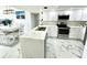 Renovated kitchen features stylish countertops, stainless steel appliances, and adjacent dining area at 1380 Gulf Blvd # 805, Clearwater, FL 33767