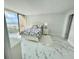 Bright bedroom with balcony access offering ocean views, stylish flooring and a comfortable bed at 1380 Gulf Blvd # 805, Clearwater, FL 33767