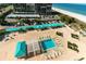 Overhead view of the complex's pool area with lounge chairs and ample parking near the beach, ideal for relaxation at 1380 Gulf Blvd # 805, Clearwater, FL 33767