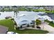 Scenic aerial view of a waterfront home with lush landscaping and a tranquil view of the adjacent lake at 1407 Brattleboro Cir, Sun City Center, FL 33573