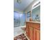 Bathroom with frosted glass shower doors, vanity, and sink at 1407 Brattleboro Cir, Sun City Center, FL 33573