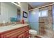 Bathroom featuring a vanity with a stone countertop and a tiled walk-in shower at 1407 Brattleboro Cir, Sun City Center, FL 33573