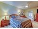 Cozy bedroom featuring a comfortable bed with patterned bedding and a ceiling fan for added comfort at 1407 Brattleboro Cir, Sun City Center, FL 33573