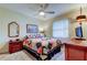Bedroom featuring a colorful quilt, ceiling fan, and natural light at 1407 Brattleboro Cir, Sun City Center, FL 33573