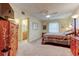 Comfortable bedroom with an en-suite bathroom and a ceiling fan at 1407 Brattleboro Cir, Sun City Center, FL 33573