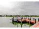 Wooden dock with boat, perfect for fishing and enjoying scenic lake views at 1407 Brattleboro Cir, Sun City Center, FL 33573