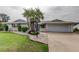 Well-manicured lawn and landscaping complement this home's exterior, complete with an attached garage and inviting driveway at 1407 Brattleboro Cir, Sun City Center, FL 33573