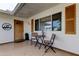 Inviting front porch seating area with wood door, accent shutters, and decorative house number display at 1407 Brattleboro Cir, Sun City Center, FL 33573