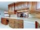 Charming kitchen featuring wood cabinets and modern white appliances at 1407 Brattleboro Cir, Sun City Center, FL 33573