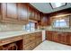 Spacious kitchen with beautiful wood cabinets, light countertops, and an eat-in bar at 1407 Brattleboro Cir, Sun City Center, FL 33573