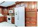 Well-organized kitchen with beautiful wood cabinets and modern white appliances at 1407 Brattleboro Cir, Sun City Center, FL 33573