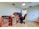 Bright home office with a wooden desk, shelving, an office chair, and lots of natural light at 1407 Brattleboro Cir, Sun City Center, FL 33573