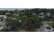 An aerial shot of this property highlights the mature trees on a lush and green corner lot at 152 58Th S Ave, St Petersburg, FL 33705