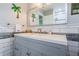 Modern bathroom with subway tile, gray vanity, and updated fixtures at 152 58Th S Ave, St Petersburg, FL 33705