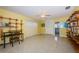 Well-lit yellow bedroom with a desk and built-in bookshelves, filled with natural light at 152 58Th S Ave, St Petersburg, FL 33705