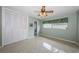 Bright bedroom with closet, vintage ceiling fan and large windows at 152 58Th S Ave, St Petersburg, FL 33705